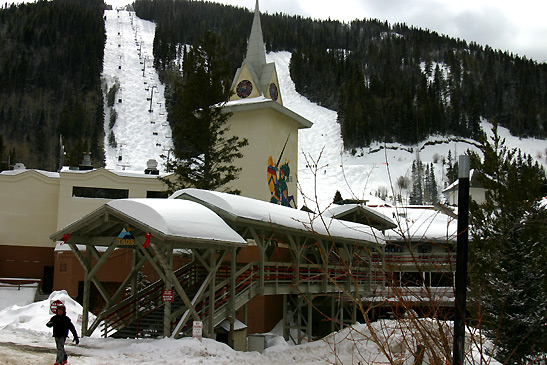 the Alpine Village Suites with ski slopes in the background, Taos Ski Valley