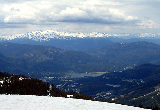 view of the Coast Mountains and the valley below from a ski slope at Whistler Blackcomb