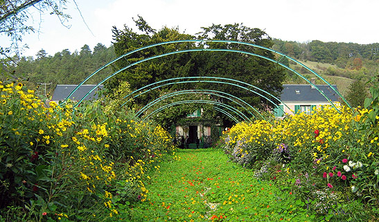 Monet's Garden showing flowers with his house in the background, Giverny