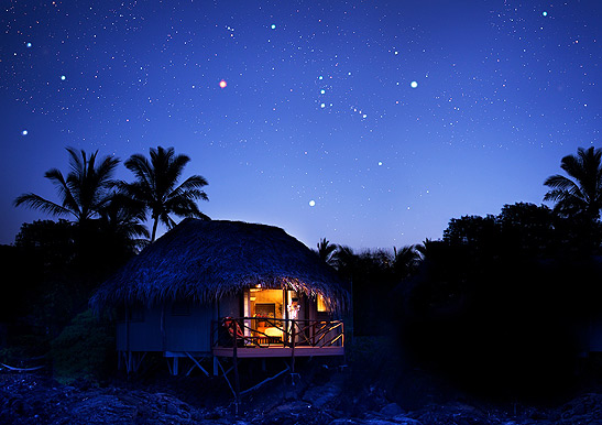 an occupied hut at night, Kona Village Resort