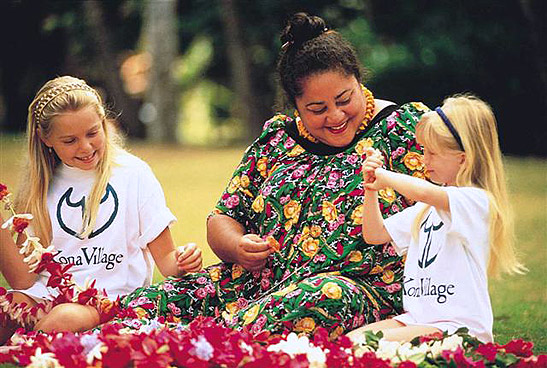 Kona Village resort staff with two young guests