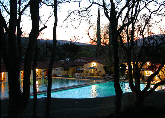 view of two pools at dusk