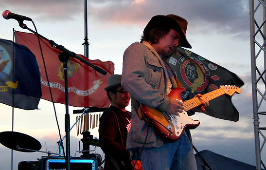 Lukas Nelson performing with John Avila on bass in the background