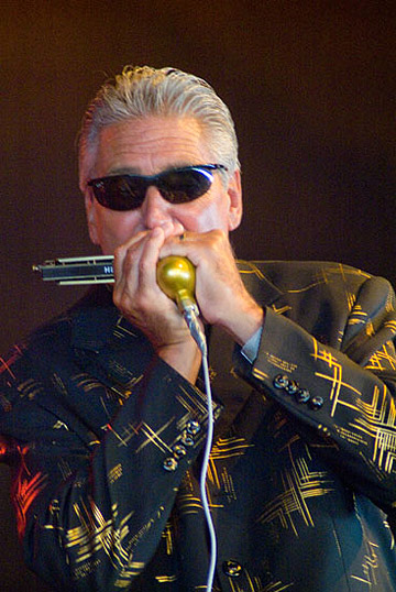 Rod Piazza on harmonica at a concert with the Mighty Flyers