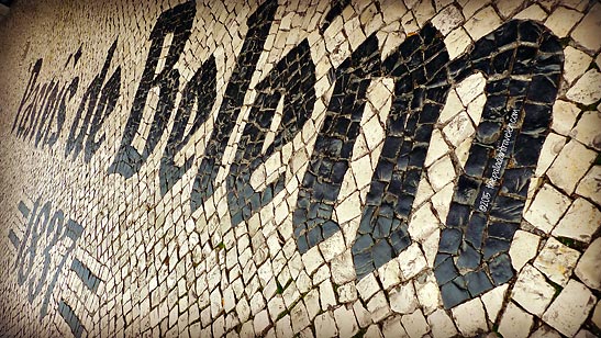Pastéis de Belém inscription on decorative mosaic cobbled street