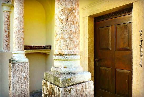 columns and wooden door at The Sanctuary of Our Lady of Carravaggio, Deggia