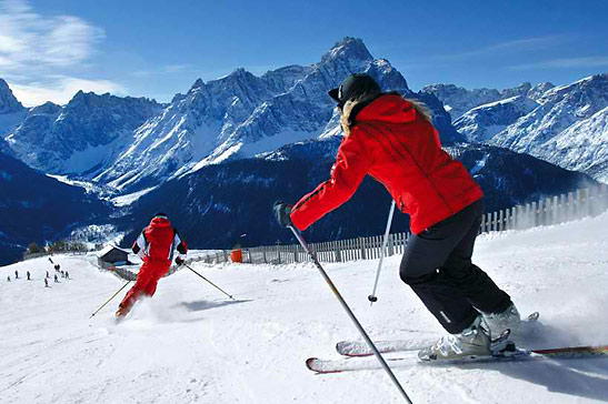 skiiers making run down Monte Elmo, Dolomites, Italy