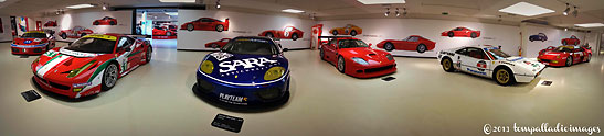 red, blue and white Ferraris on display at the Museo Ferrari
