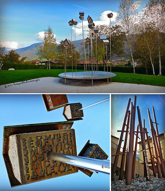 the Il Museo delle Palafitte di Fiave's park-like grounds including a bird house sculpture