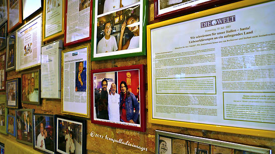 accolades and photos on a wall at Gelateria di Piazza