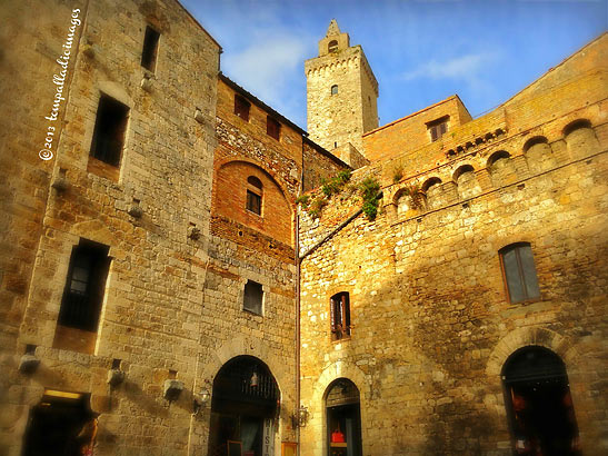 medieval buildings in San Gimignano with a tower in the background