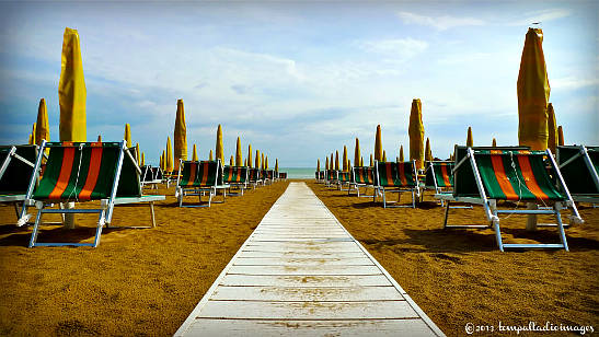 rows of folded bech umbrellas and chairs, Senigallia