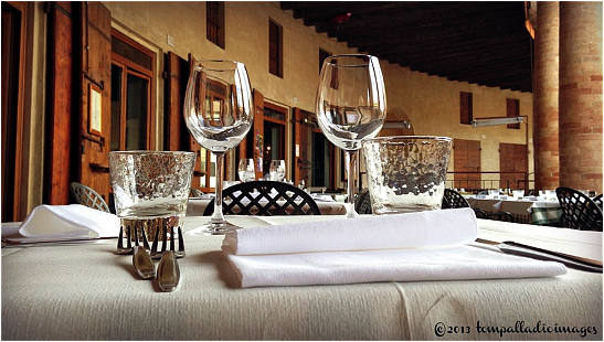 table setting at a restaurant under the Foro Annonario's colonnades