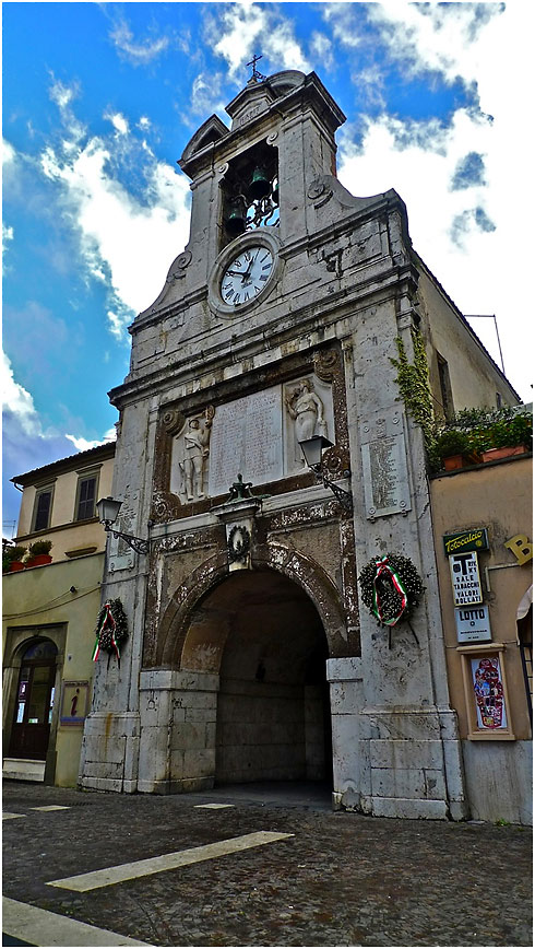 main clock tower and pedestrian passageway in Piazza del Commune, Sutri, Lazio, Italy