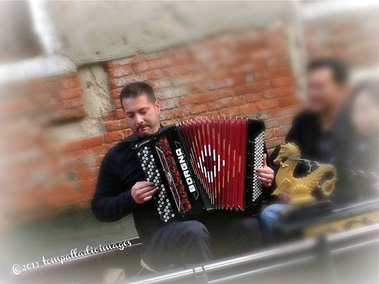 accordion player serenading gondola passengers