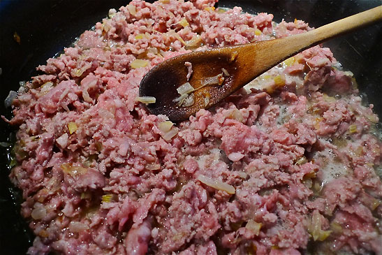 pork, onion-celery mixture cooking in red wine and olive oil