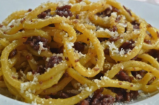grated parmigiano-reggiano cheese over cooked bigoli al tastasale